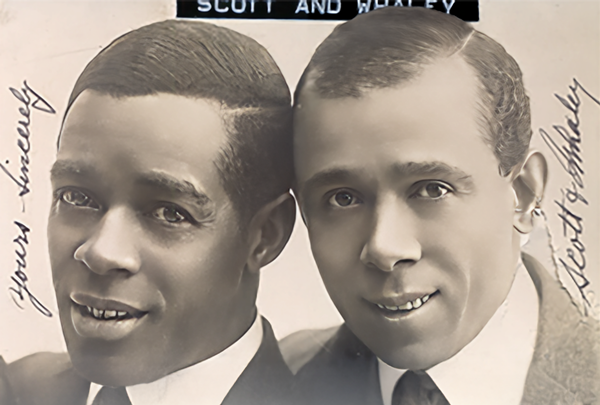 close up head & shoulders portrait photo of two young black men, with handwritten inscription: 'Yours sincerely, Scott & Whaley'..